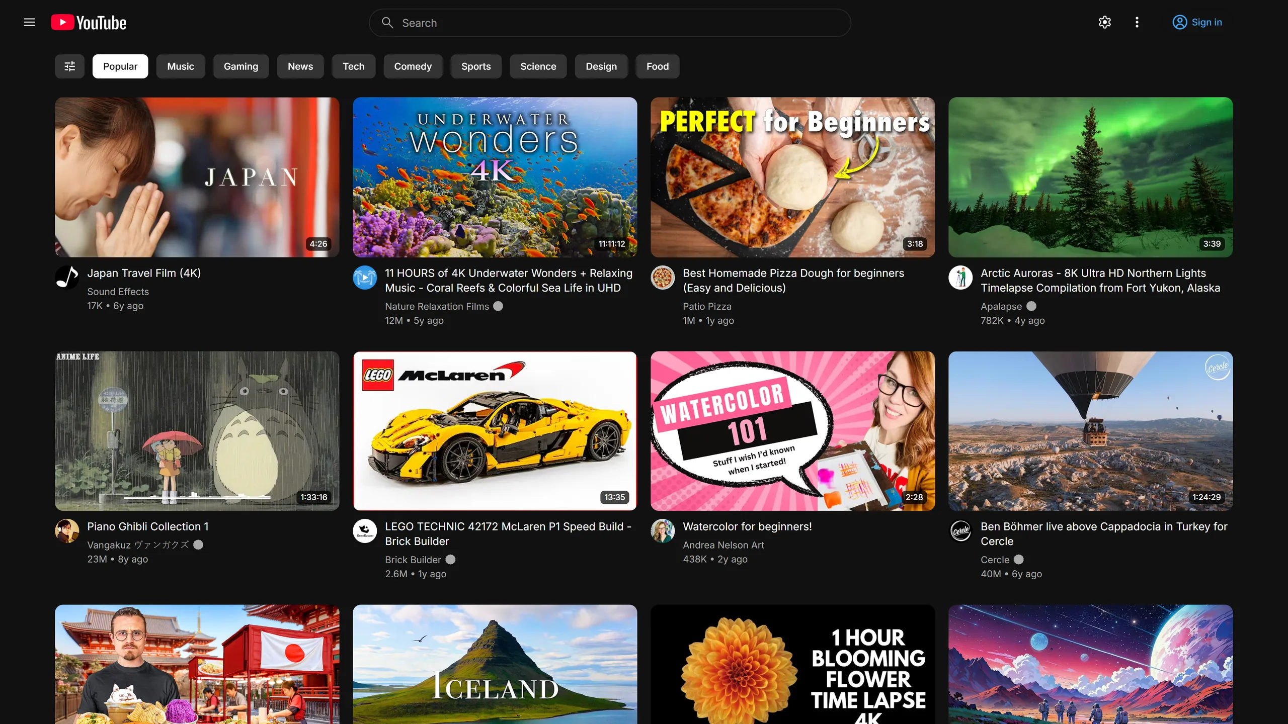 Home with the sidebar hidden, leaving only the topic chips and a full-width grid of videos.
