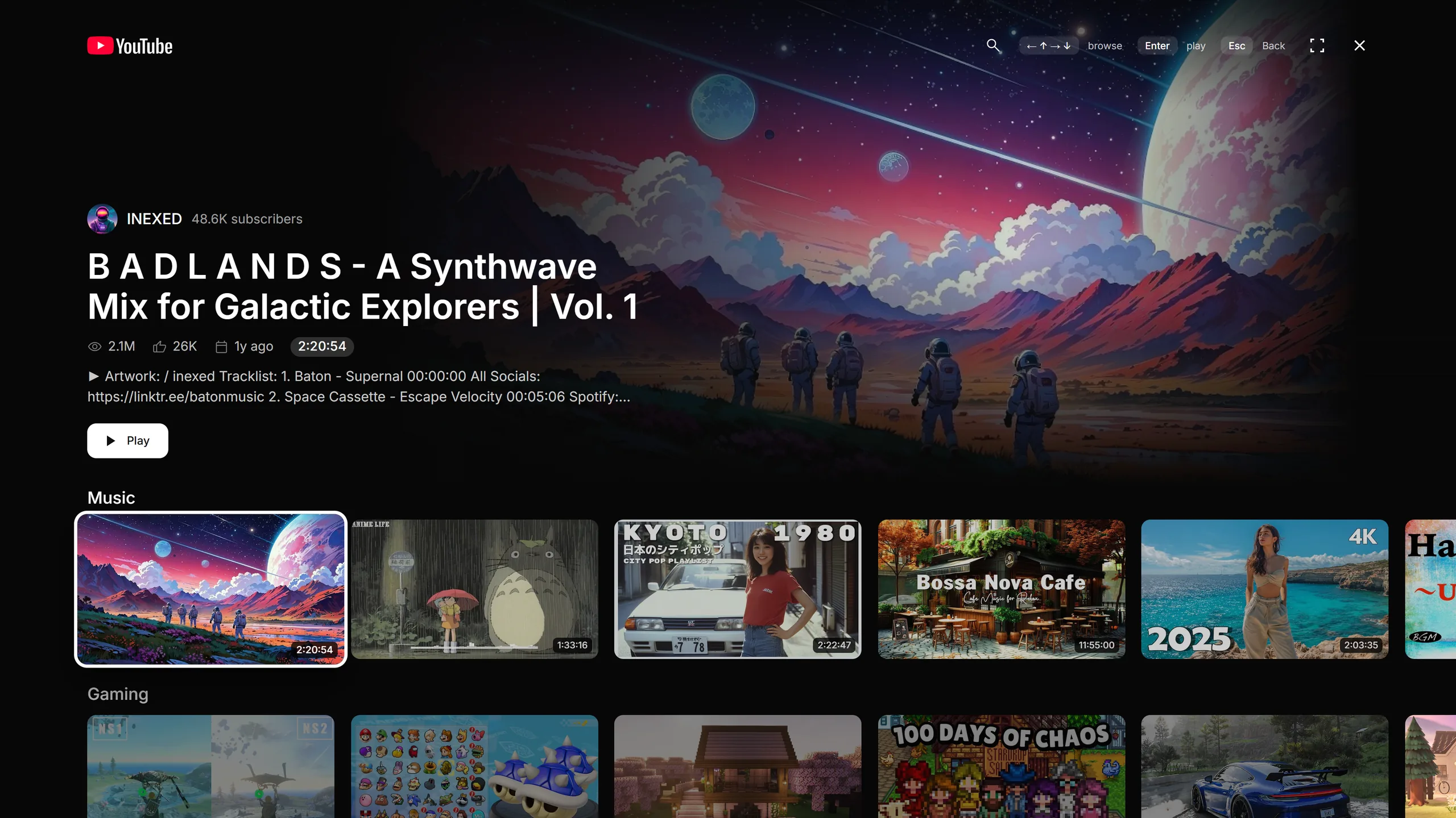 Reframe's TV Mode: the selected video fills a dark full-screen backdrop with its title and a Play button, above a Music shelf of large thumbnails.